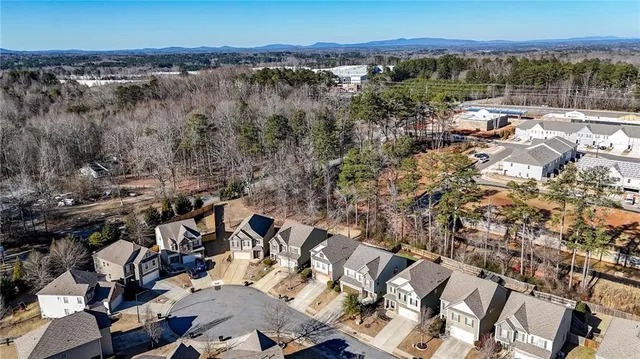 an aerial view of a residential apartment building with a yard