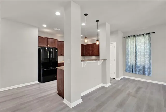 a kitchen with a sink a refrigerator and a fireplace
