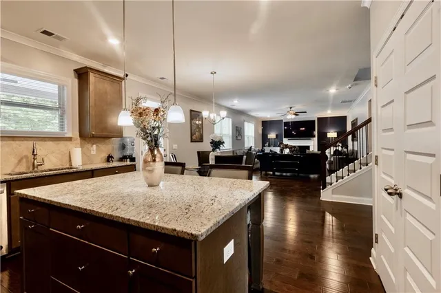 a kitchen with sink and refrigerator