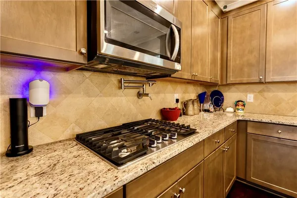 a kitchen with a stove a sink and a cabinets