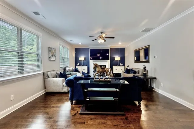 a living room with fireplace furniture and a large window