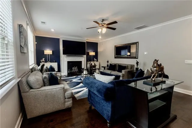 a living room with furniture a flat screen tv and a fireplace