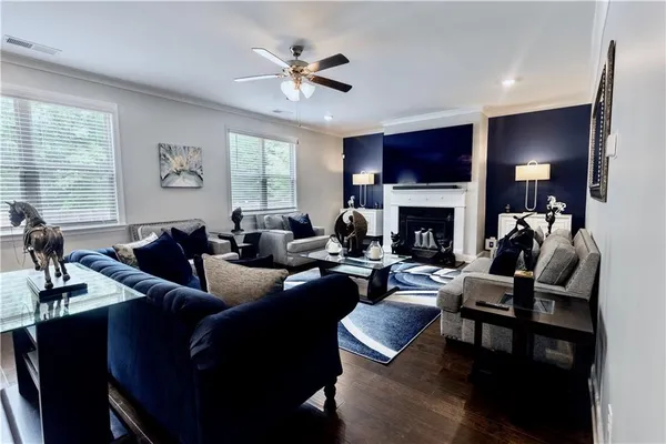 a living room with furniture a flat screen tv and a fireplace