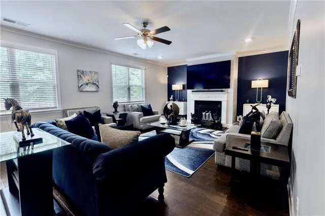 a living room with furniture a flat screen tv and a fireplace