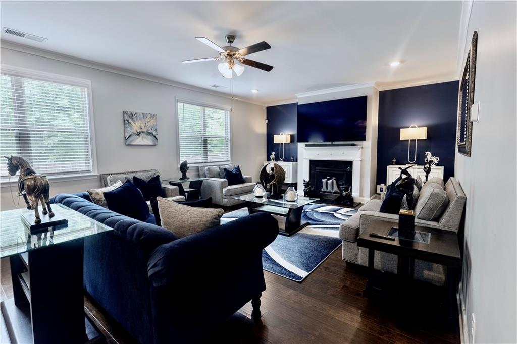 133 Canal Street Hampton, GA 30228 - Photo 20 of 43 a living room with furniture a flat screen tv and a fireplace