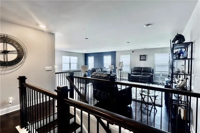a view of a kitchen with furniture and lots of frames on the wall
