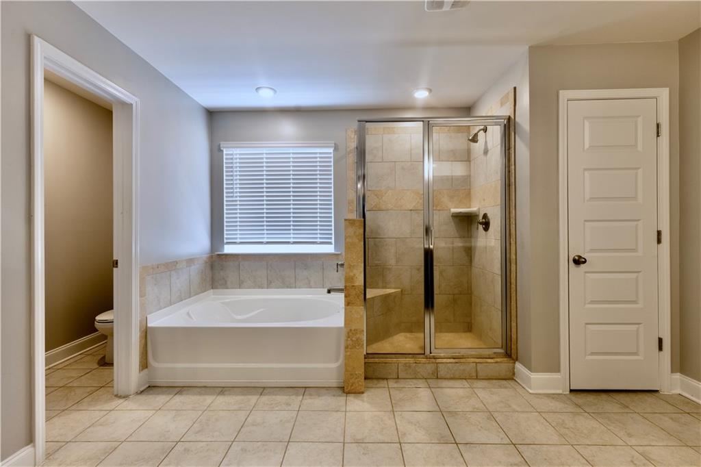 133 Canal Street Hampton, GA 30228 - Photo 30 of 43 a spacious bathroom with a tub shower and sink
