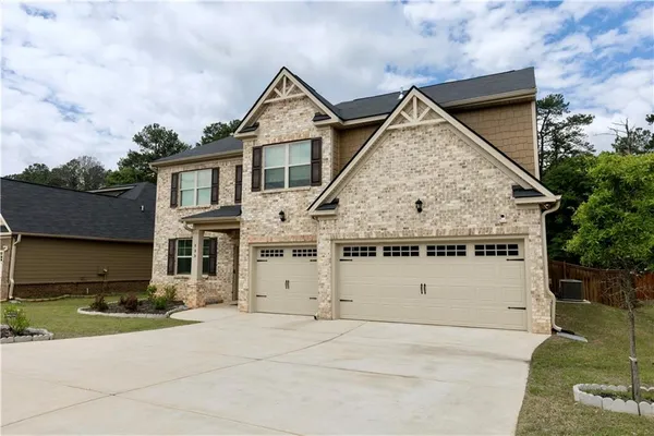 a view of a big house with wooden walls