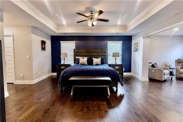 a bedroom with a bed and a chandelier