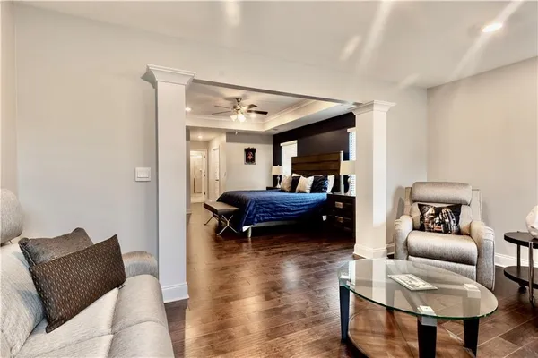 a living room with furniture and a wooden floor