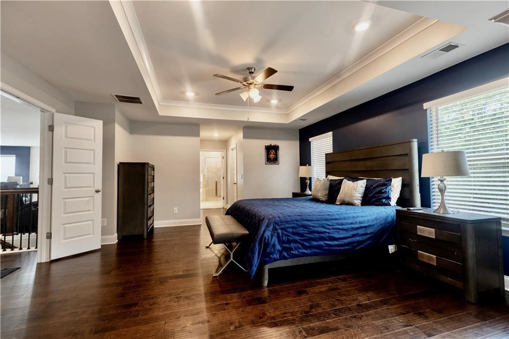 133 Canal Street Hampton, GA 30228 - Photo 35 of 43 a bed room with furniture and wooden floor