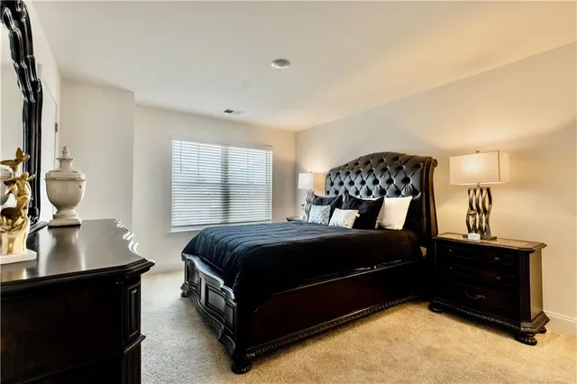 a bedroom with a bed and a dresser