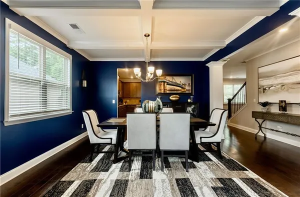 a dining room with furniture a rug and wooden floor