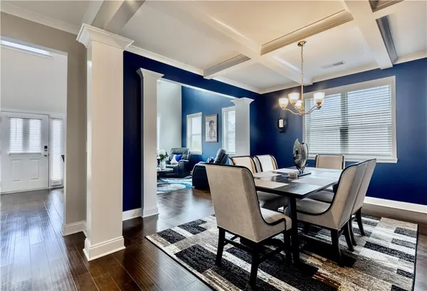 a view of a dining room with furniture and wooden floor