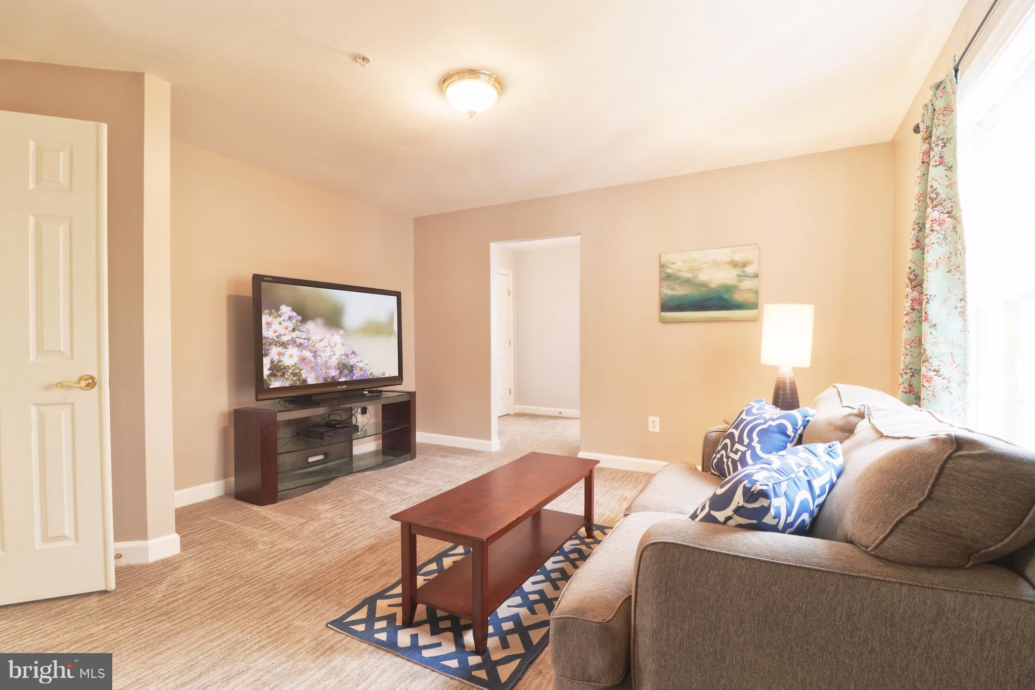14406 Dunstable Court Bowie, MD 20721 - Photo 18 of 30 a living room with furniture and a flat screen tv