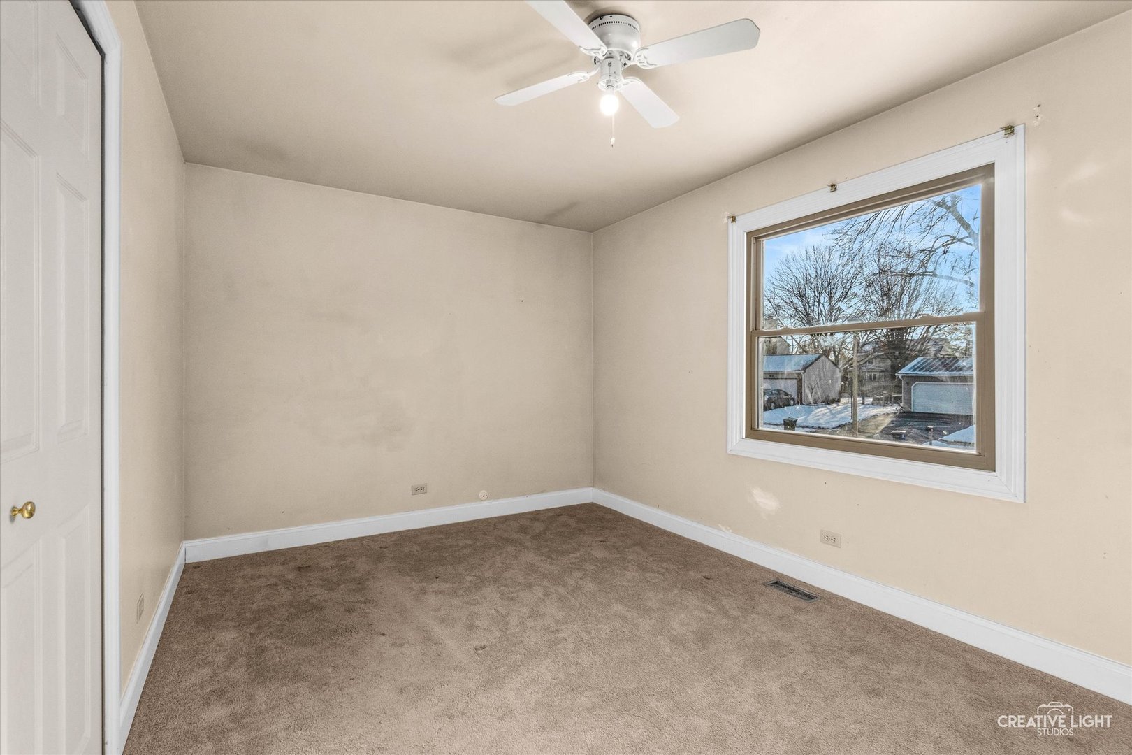 425 Carriage Hill Road Naperville, IL 60565 - Photo 16 of 37 an empty room with a window and a fan