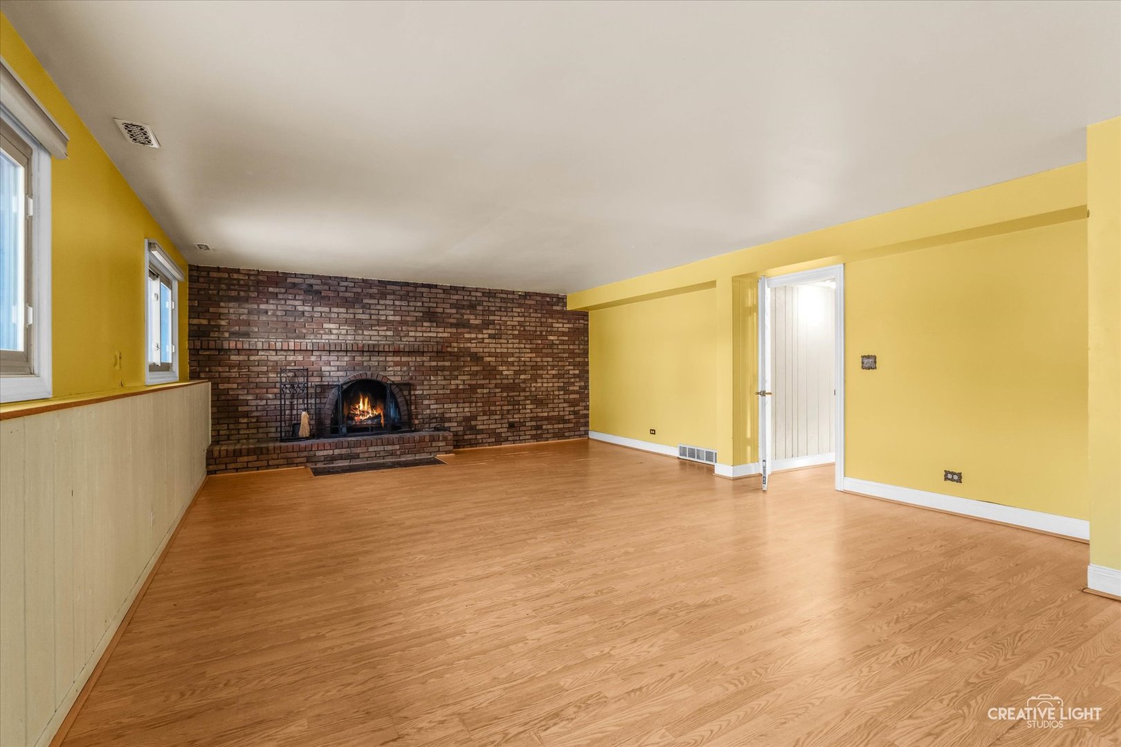 425 Carriage Hill Road Naperville, IL 60565 - Photo 19 of 37 a view of empty room with wooden floor and fireplace