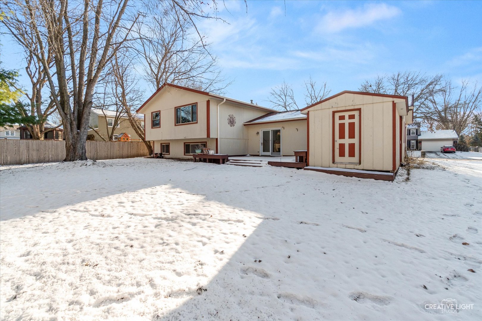 425 Carriage Hill Road Naperville, IL 60565 - Photo 27 of 37 a view of a white house with a large tree in front of it