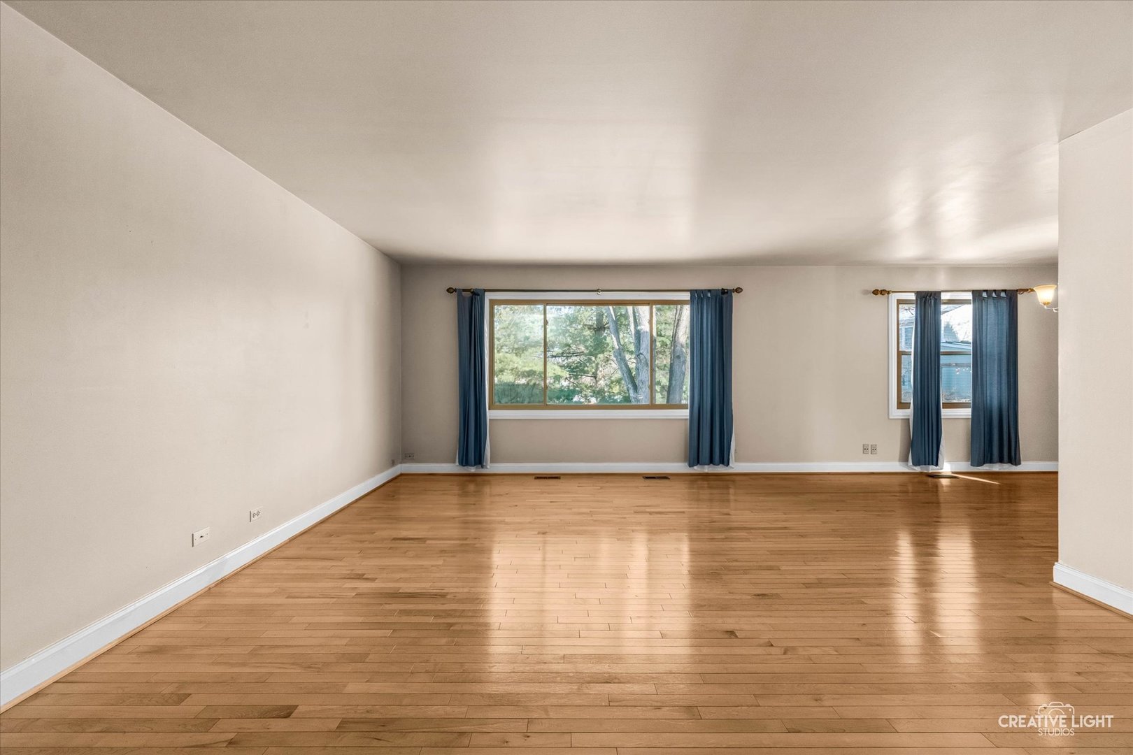 425 Carriage Hill Road Naperville, IL 60565 - Photo 6 of 37 a view of an empty room with wooden floor and a window
