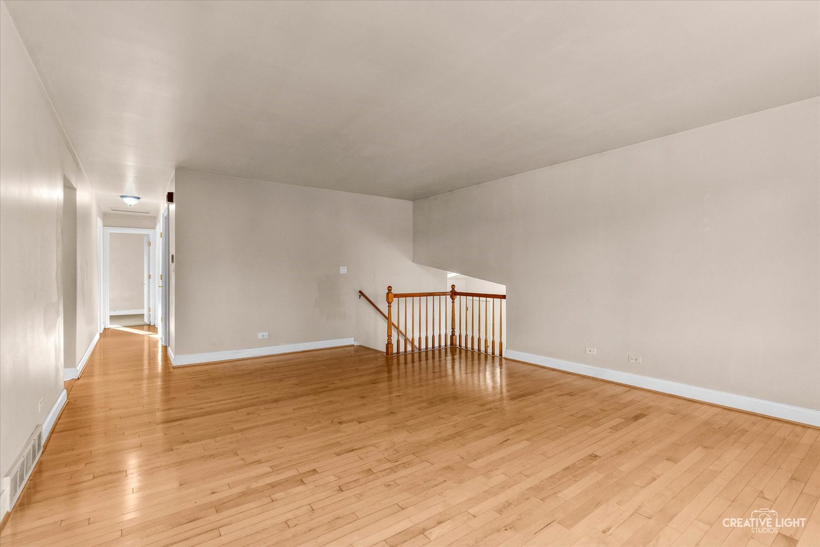 425 Carriage Hill Road Naperville, IL 60565 - Photo 8 of 37 a view of an empty room with wooden floor and a window