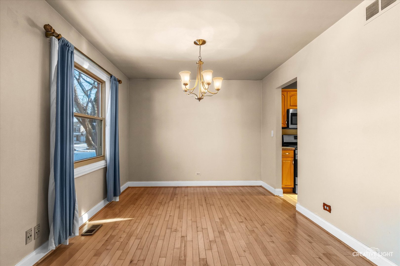 425 Carriage Hill Road Naperville, IL 60565 - Photo 9 of 37 wooden floor in an empty room with a window