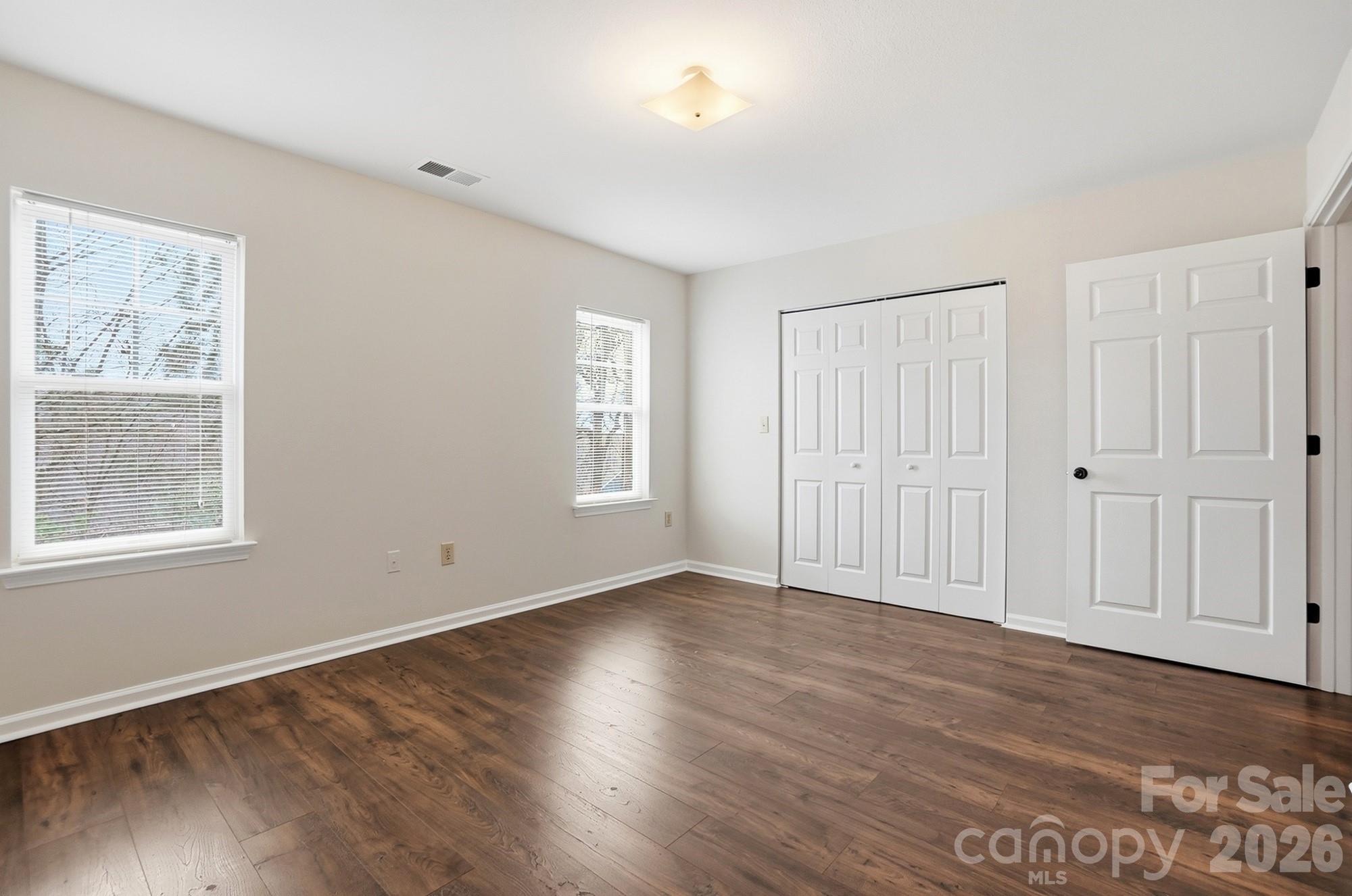 711 Stone Village Drive Fort Mill, SC 29708 - Photo 36 of 46 an empty room with wooden floor and windows