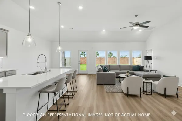 a large kitchen with kitchen island a sink stainless steel appliances and cabinets