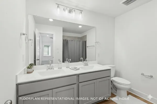 a bathroom with a bathtub a shower and a sink