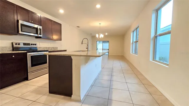 a kitchen with stainless steel appliances granite countertop a sink and a microwave