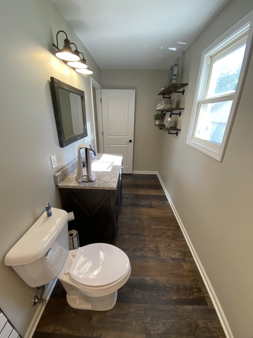 430 South 1st Street DeKalb, IL 60115 - Photo 19 of 34 a bathroom with a toilet sink and mirror