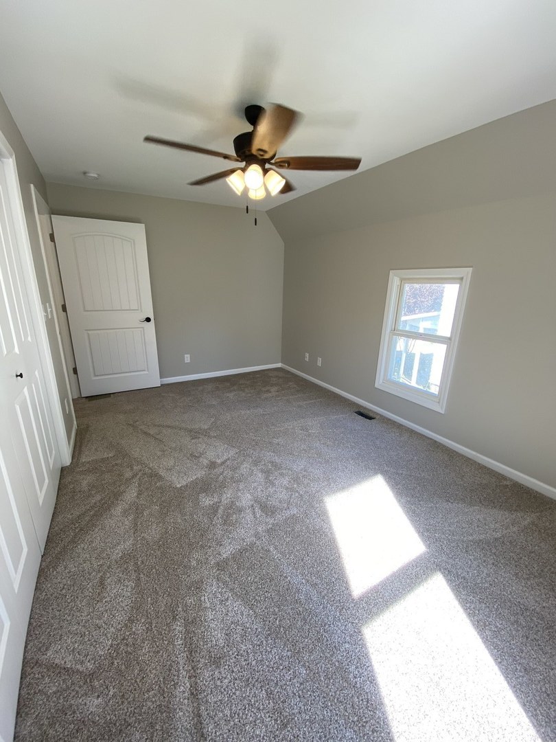 430 South 1st Street DeKalb, IL 60115 - Photo 31 of 34 an empty room with windows and fan