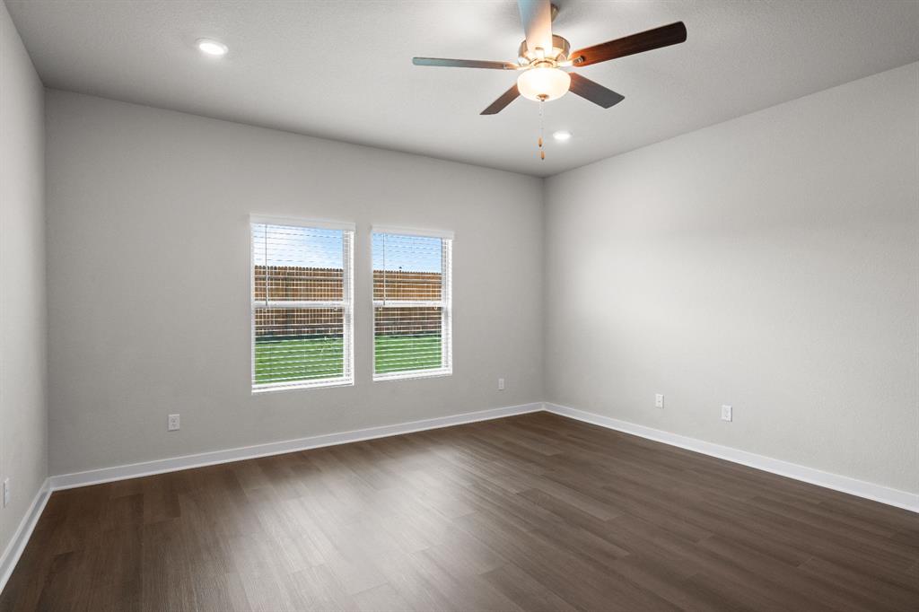177 Sleep Hollow Jarrell, TX 76537 - Photo 12 of 24 Spacious room featuring wood-finish flooring, light-toned walls, two windows with blinds, a ceiling fan with integrated lighting, and recessed ceiling lights