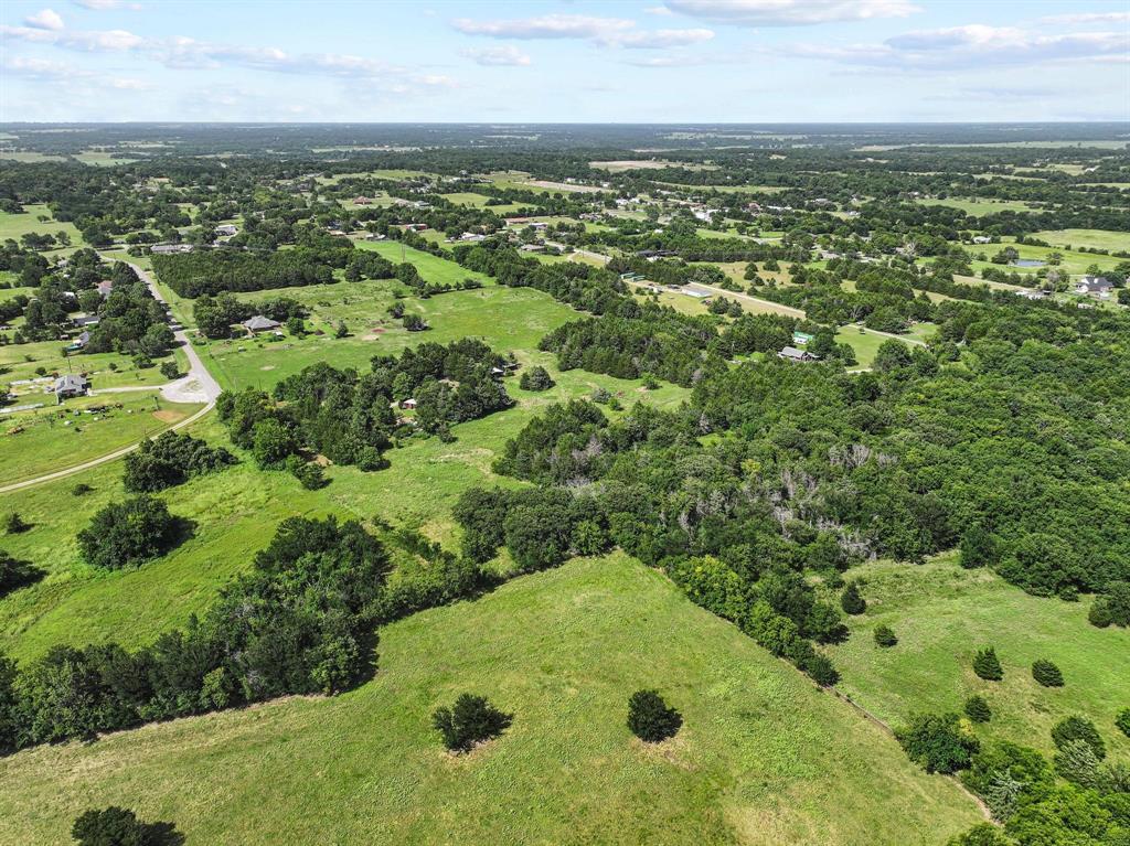252 Meadow Lake Estates Road Denison, TX 75021 - Photo 34 of 37 Expansive aerial landscape featuring open green fields, clusters of mature trees, and scattered residential properties