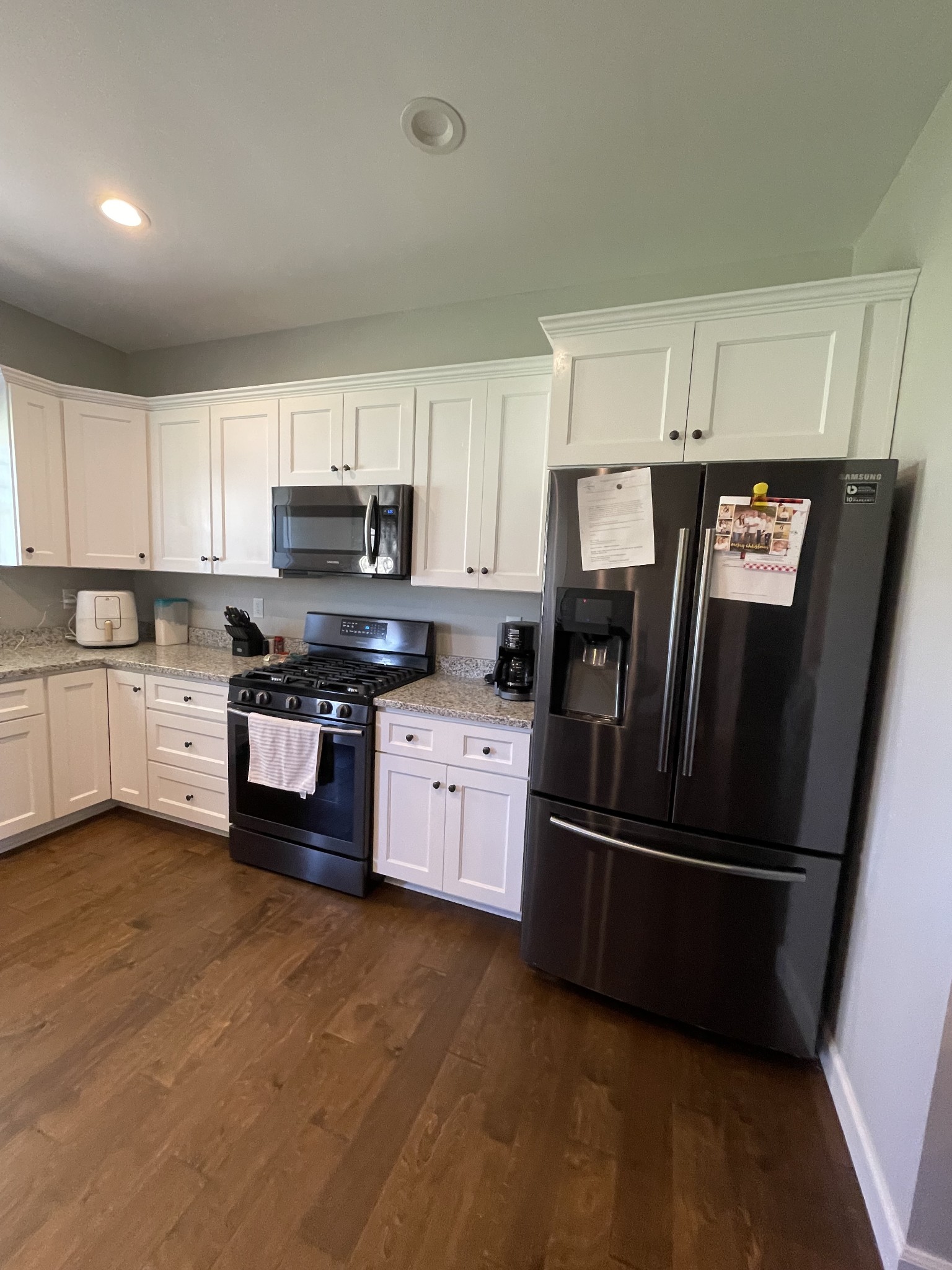 528 Matlock Road Charlotte, TN 37036 - Photo 14 of 26 a kitchen with granite countertop stainless steel appliances and white cabinets