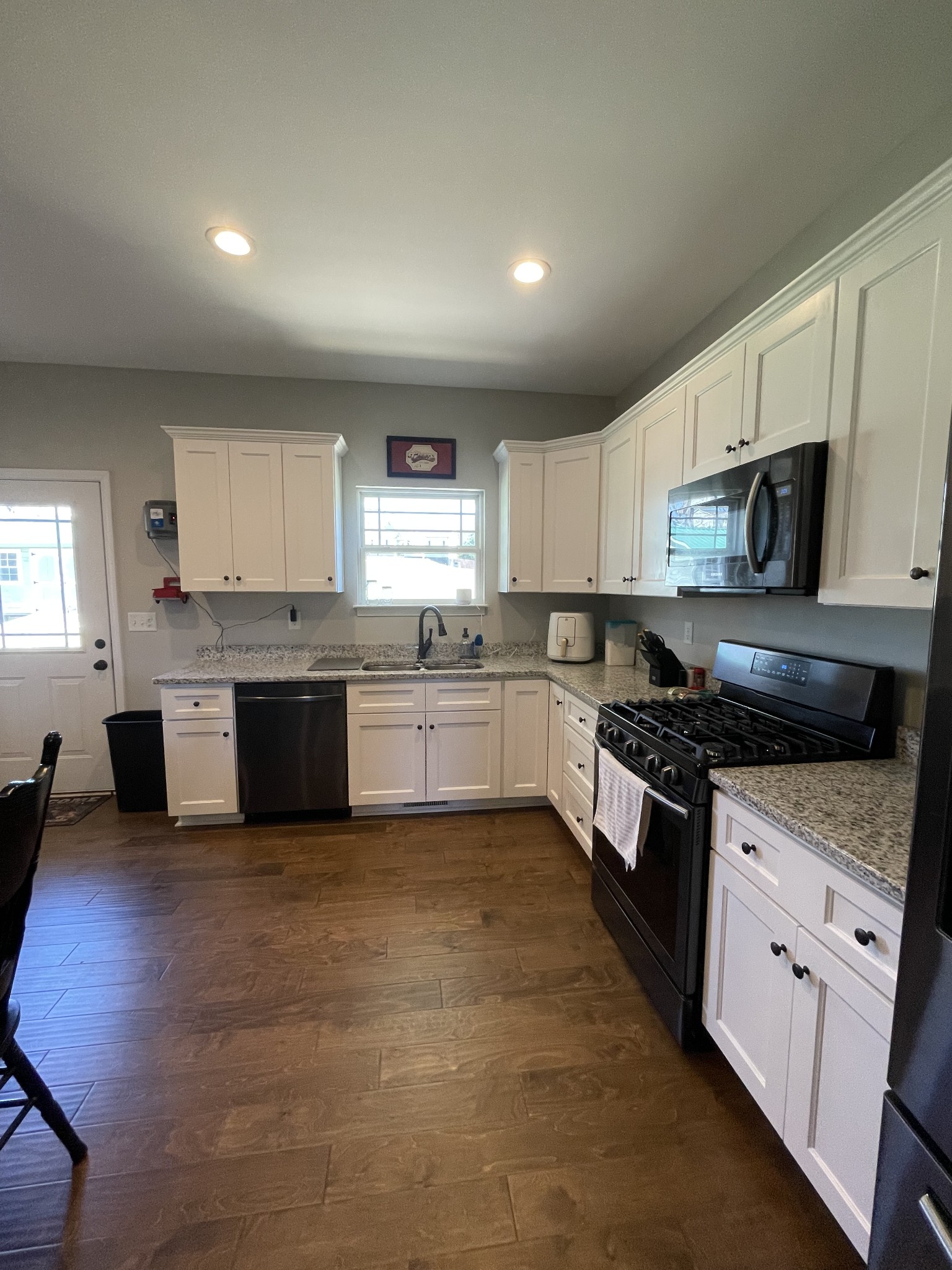 528 Matlock Road Charlotte, TN 37036 - Photo 15 of 26 a large kitchen with stainless steel appliances granite countertop a stove sink and cabinets