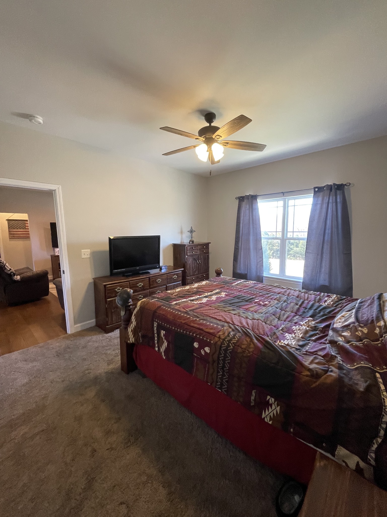 528 Matlock Road Charlotte, TN 37036 - Photo 17 of 26 a spacious bedroom with a bed and a chandelier