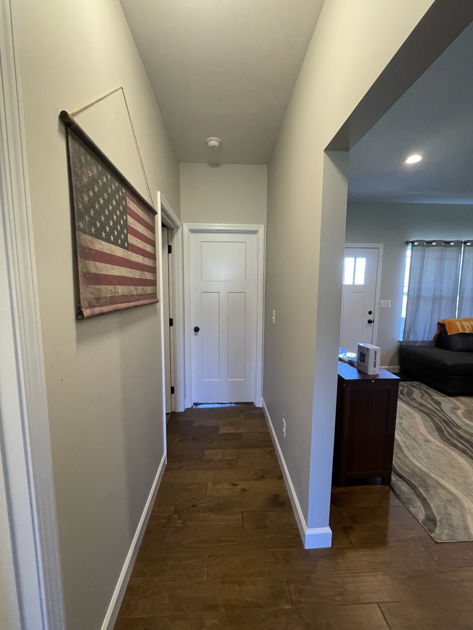 528 Matlock Road Charlotte, TN 37036 - Photo 21 of 26 a view of a hallway to a livingroom with wooden floor and furniture