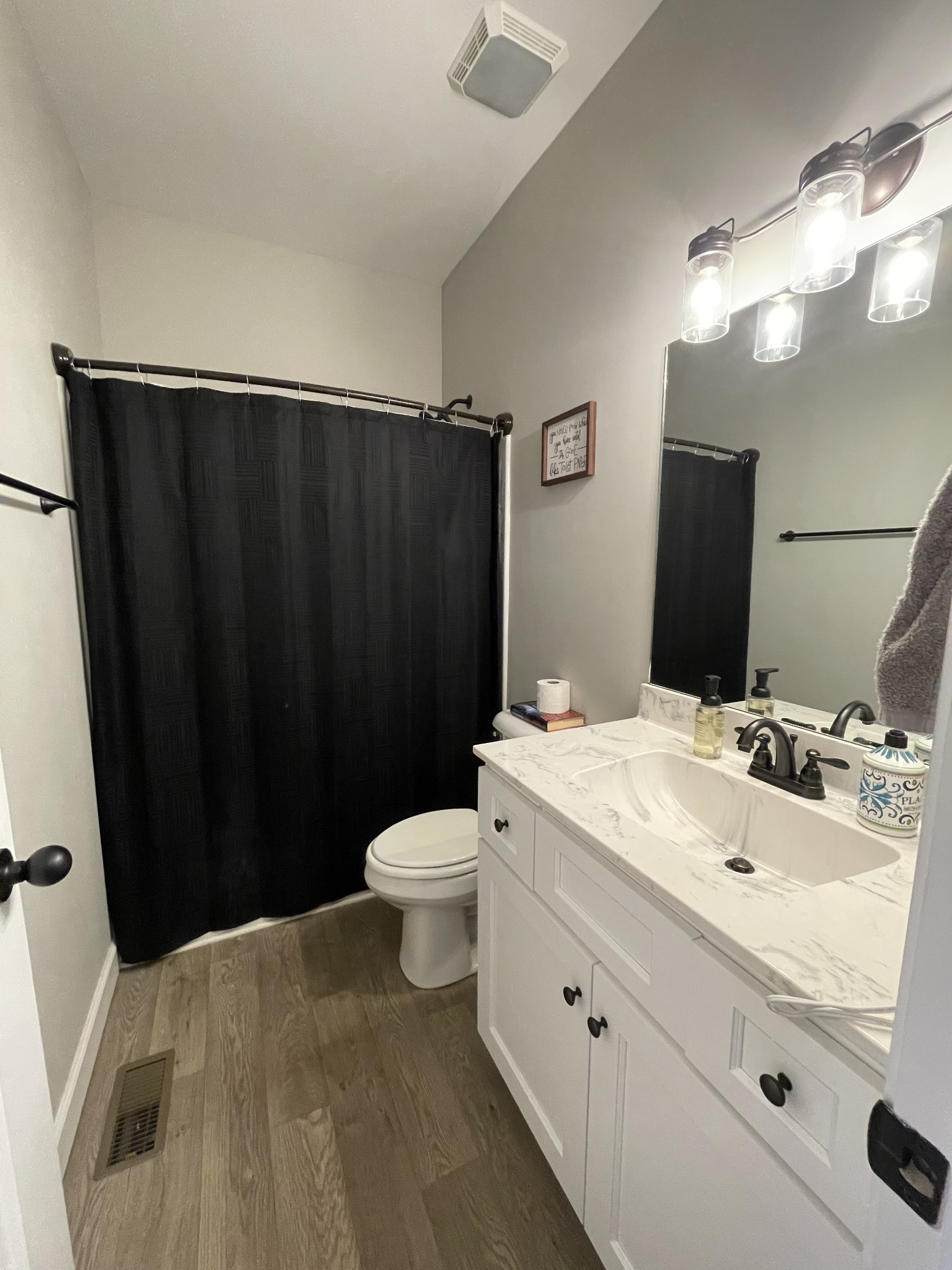 528 Matlock Road Charlotte, TN 37036 - Photo 24 of 26 a bathroom with a sink and a mirror