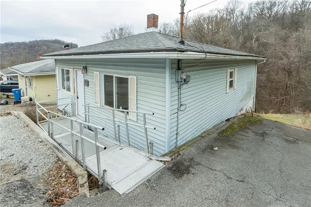 a view of a house with wooden fence