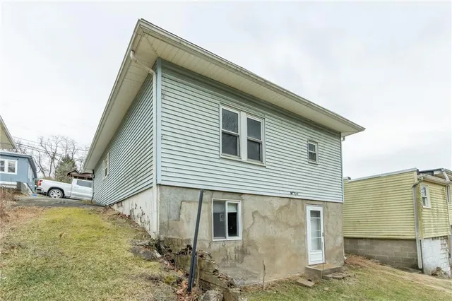 a view of a house with wooden fence