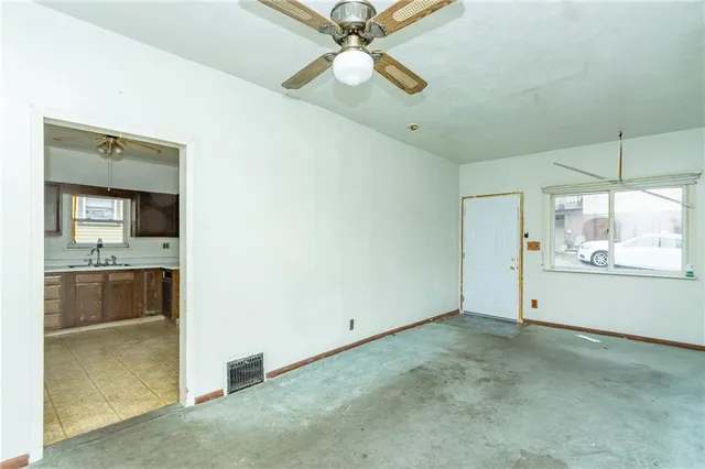 a view of a room with window and ceiling fan