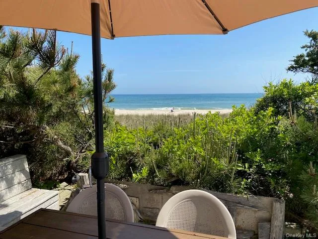 a view of yard from deck with patio