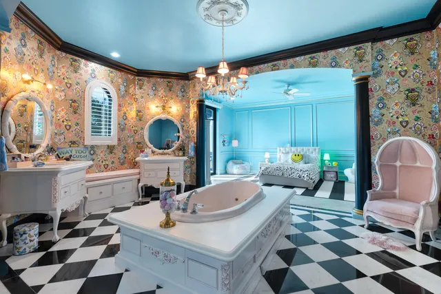 a view of a swimming pool with a garden and patio