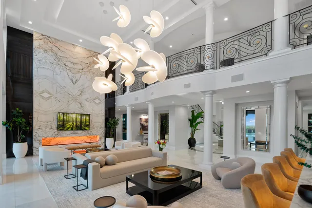 a living room with furniture potted plant and a large window