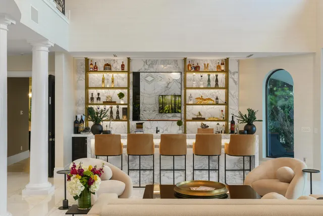 a kitchen with stainless steel appliances kitchen island granite countertop a stove a sink and a white cabinets