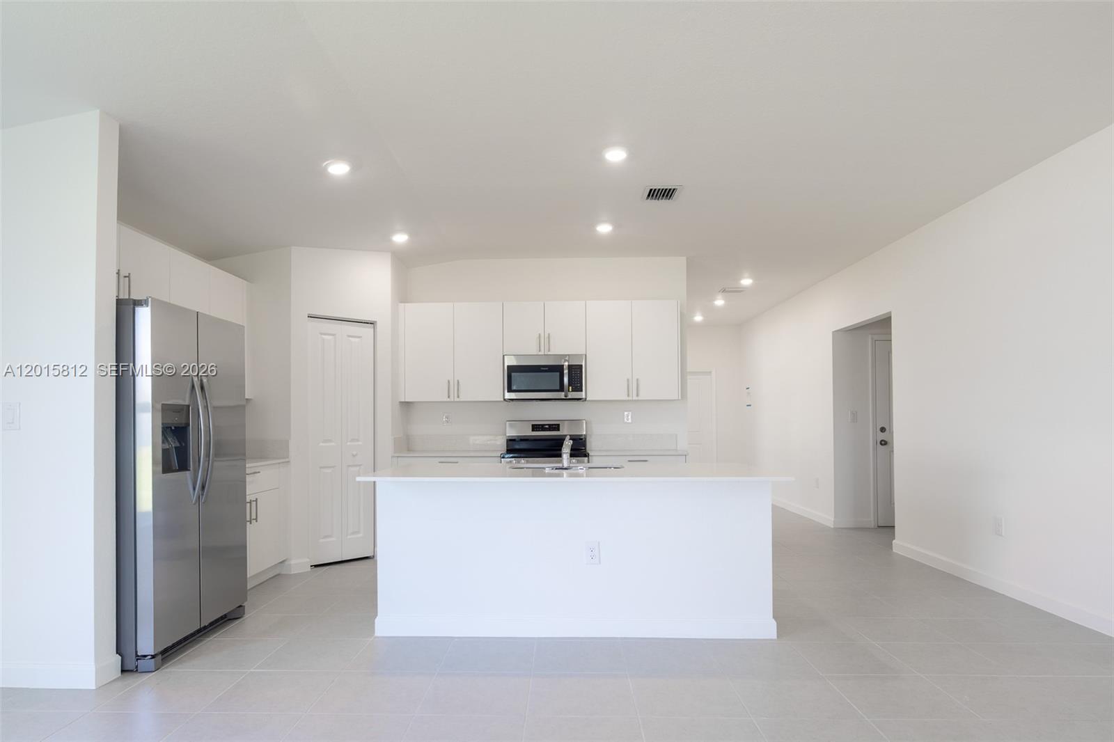 17564 Southwest 285th Street Homestead, FL 33030 - Photo 3 of 42 a kitchen with stainless steel appliances kitchen island a refrigerator sink and cabinets