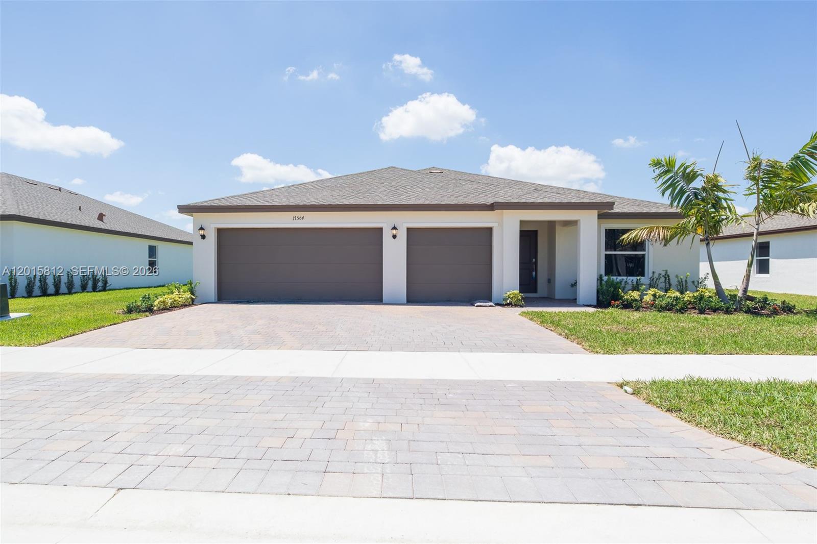 17564 Southwest 285th Street Homestead, FL 33030 - Photo 34 of 42 a front view of a house with a yard and garage
