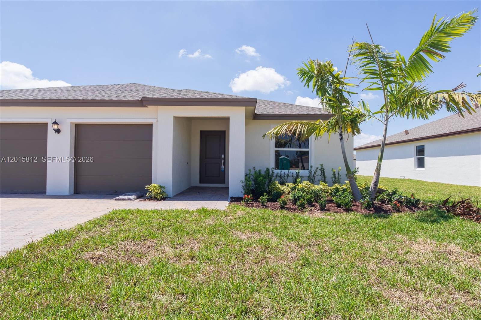 17564 Southwest 285th Street Homestead, FL 33030 - Photo 35 of 42 a front view of a house with a yard and garage