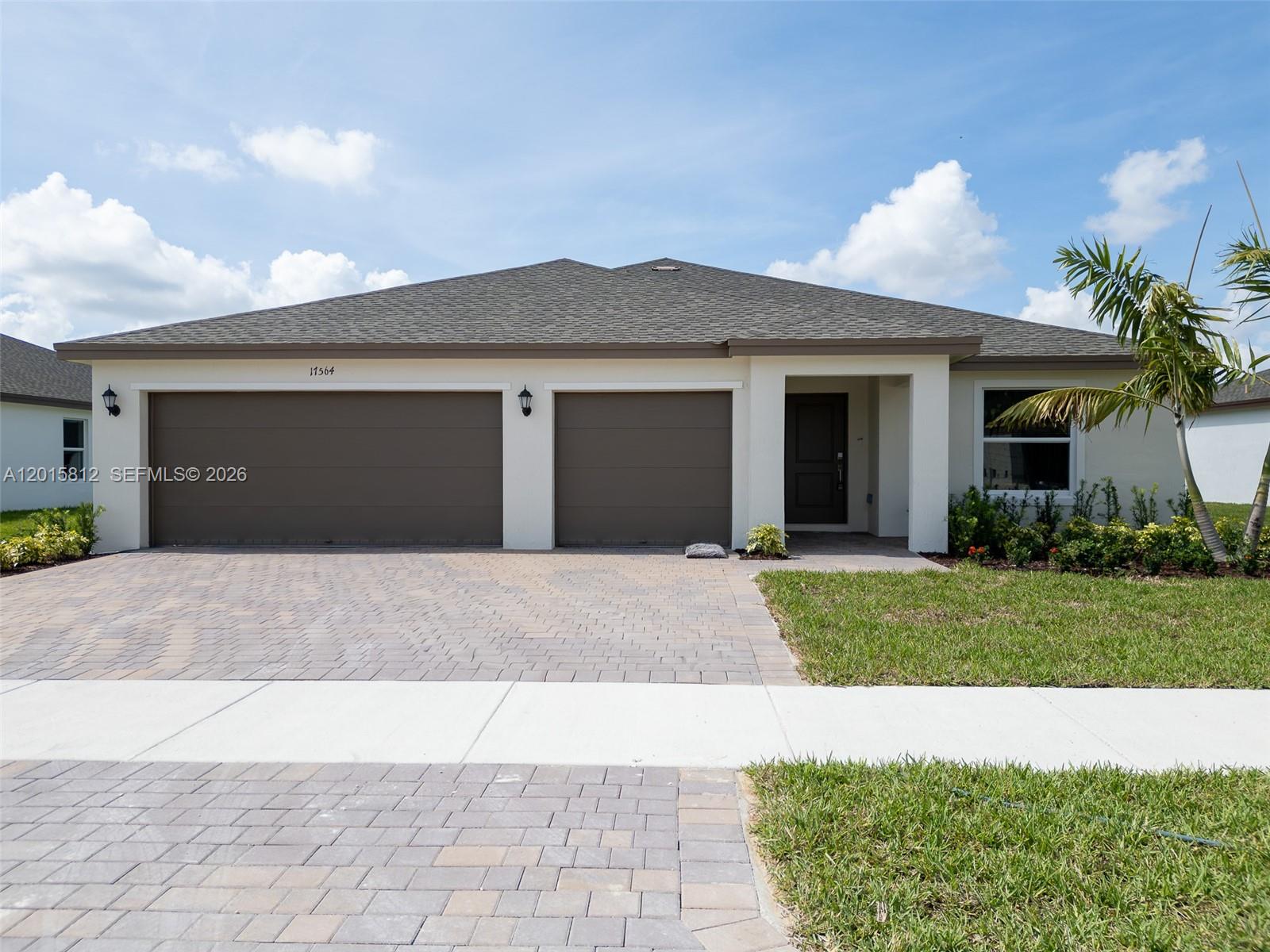 17564 Southwest 285th Street Homestead, FL 33030 - Photo 38 of 42 a view of a house with a yard and a garage