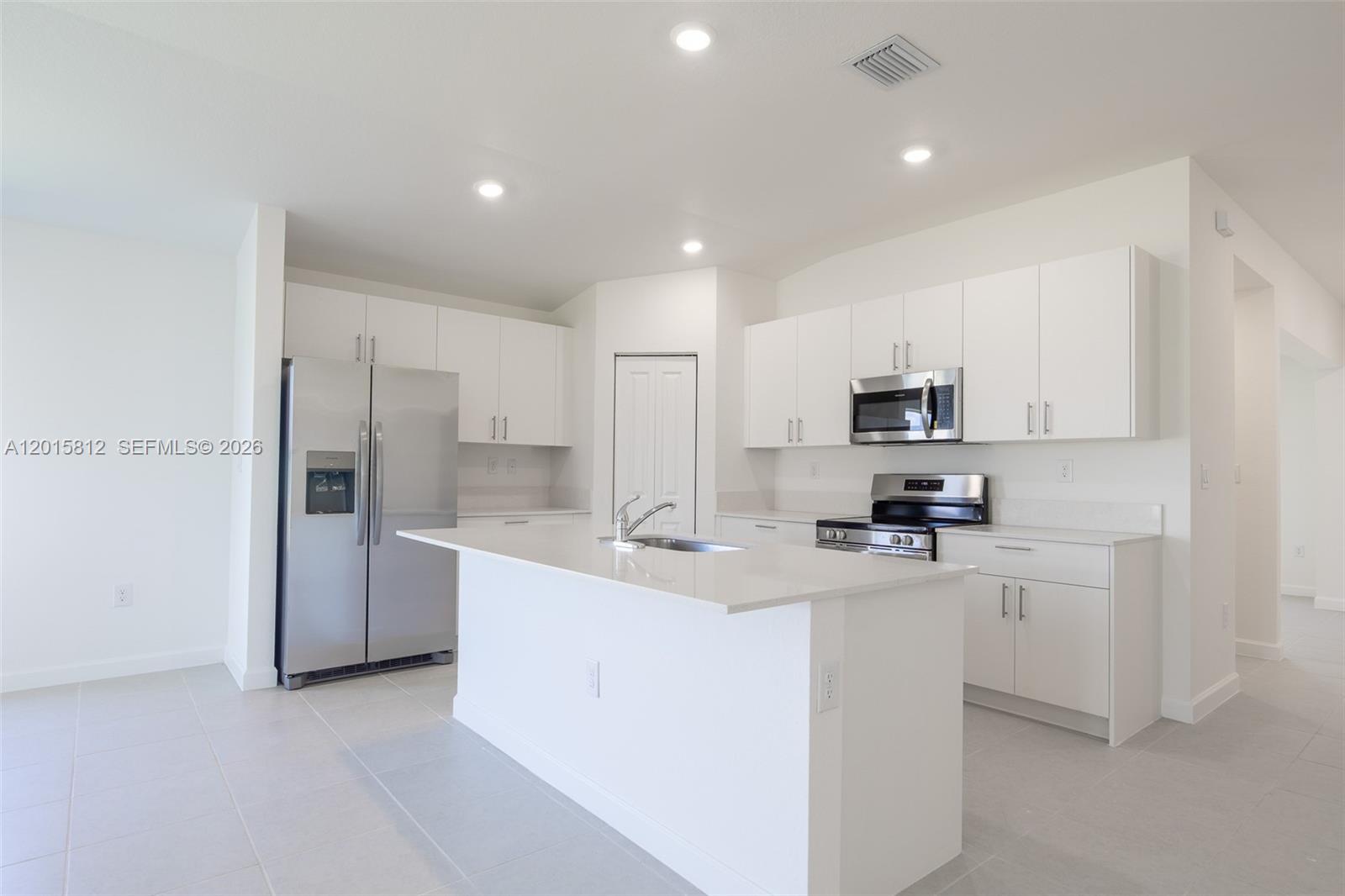 17564 Southwest 285th Street Homestead, FL 33030 - Photo 4 of 42 a kitchen with stainless steel appliances a refrigerator sink and microwave